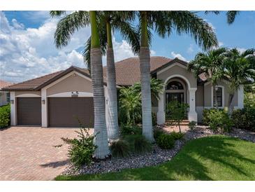 Single-Gathering home with a two-car garage and palm trees at 3439 Nighthawk Ct, Punta Gorda, FL 33950