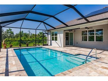 Beautiful screened-in pool with a tiled deck and seamless access to the home at 27261 Guapore Dr, Punta Gorda, FL 33983