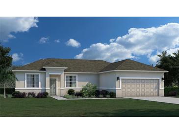 One-story home with beige exterior, two-car garage, and landscaped lawn at 378 Lawler St, Port Charlotte, FL 33954