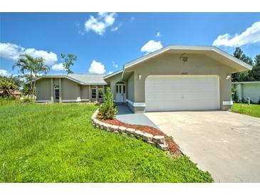 Single-Gathering home with two-car garage and landscaped yard at 20222 Banner Ave, Port Charlotte, FL 33952