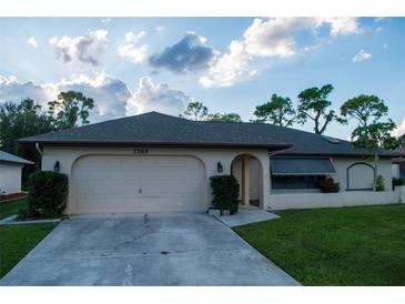 Single-story home with a two-car garage and a well-maintained lawn at 1565 Dorchester St, Port Charlotte, FL 33952
