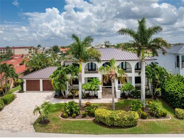 Luxury waterfront home with a large yard and beautiful landscaping at 28 Colony Point Dr, Punta Gorda, FL 33950