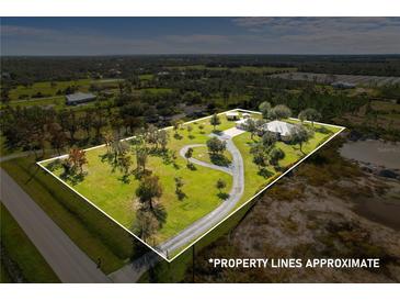 Aerial view of single-Gathering home on a large lot with a long driveway at 32121 Washington Loop Rd, Punta Gorda, FL 33982