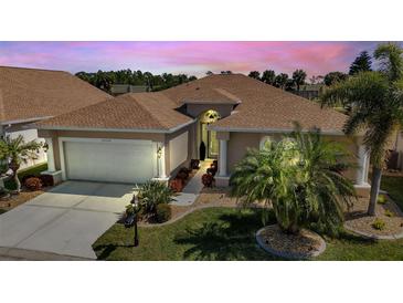 One-story home with tile roof and landscaped front yard at 24588 Buckingham Way, Port Charlotte, FL 33980