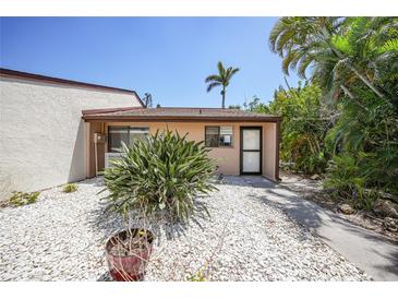 Charming single-story home featuring desert landscaping and a neutral exterior paint scheme on a sunny day at 1001 W Marion Ave # 14, Punta Gorda, FL 33950