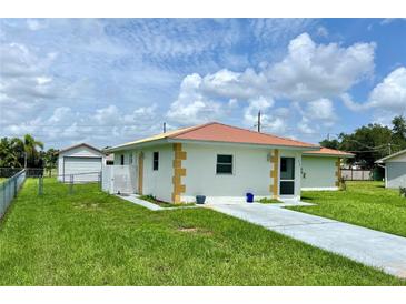 Single story home with attached garage and spacious yard at 512 Chamber Nw St, Port Charlotte, FL 33948