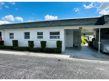 Front view of condo with carport and well manicured hedges at 7739 38Th N Pl, St Petersburg, FL 33709