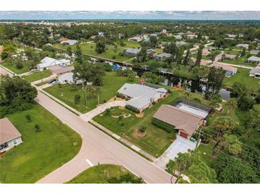 Aerial view of canal front property with a large house at 2216 Pellam Blvd, Port Charlotte, FL 33948