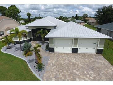 Single-Gathering home with two-car garage and landscaped yard at 23098 Ambassador Ave, Port Charlotte, FL 33954