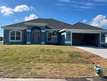 Newly constructed home with a two-car garage and well-manicured lawn at 10133 Audrey St, Port Charlotte, FL 33981