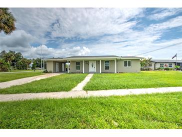 Newly renovated home with a carport and landscaped yard at 1638 Harmony Dr, Port Charlotte, FL 33952