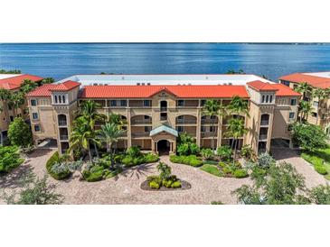 Aerial view of Mediterranean style building, lush landscaping at 89 Vivante Blvd # 305, Punta Gorda, FL 33950