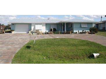 Cute beachfront home with light blue exterior and metal roof at 305 W Tarpon Nw Blvd, Port Charlotte, FL 33952