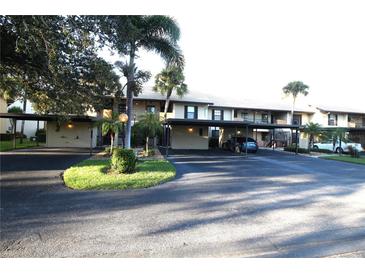Exterior view of condo building with covered parking at 255 Mission S Trl # J, Venice, FL 34285