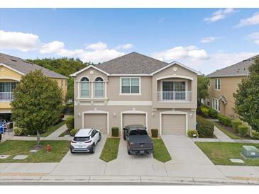 Two-story townhome with two-car garage and balcony at 8734 Moonlit Meadows Loop, Riverview, FL 33578