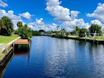 Tranquil waterfront property featuring a private dock and picturesque canal views at 181 N Waterway Nw Dr, Port Charlotte, FL 33952