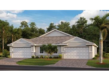 Charming home showcasing a well-manicured lawn, double garage, and beautiful landscaping at 16390 Bridle Ridge St, Port Charlotte, FL 33953