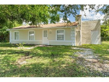 Cute single story home with a well-manicured lawn and mature trees at 2624 Lee St, Punta Gorda, FL 33950