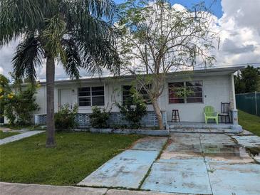 Exterior view of a single-story home with a white facade and landscaping at 8274 Herbison Ave, North Port, FL 34287