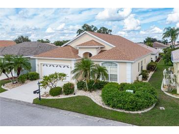 Single-story house with a two-car garage and landscaped yard at 1676 Palace Ct, Punta Gorda, FL 33980