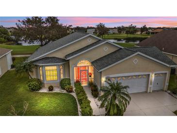 Attractive single-Gathering home with two-car garage, nicely landscaped at 24083 Buckingham Way, Port Charlotte, FL 33980