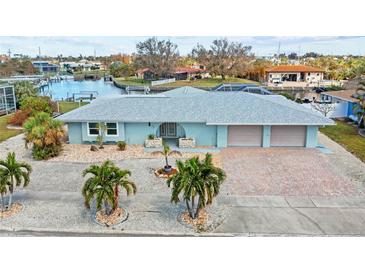 Stunning aerial view showcasing the home's canal-front location at 156 Morgan Se Ln, Port Charlotte, FL 33952