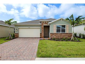 Single-story home with a two-car garage and attractive landscaping at 16024 Crofton Springs Way, Port Charlotte, FL 33953
