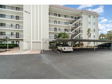 Covered parking area for residents with additional guest parking at 9011 Midnight Pass Rd # 329, Sarasota, FL 34242