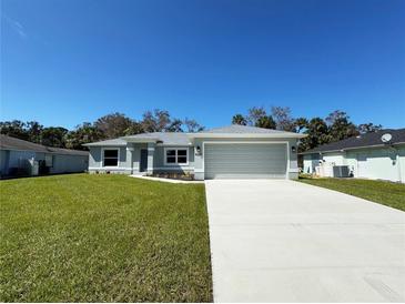 Newly built home with a two-car garage and well-manicured lawn at 4089 Appleton Ter, North Port, FL 34286