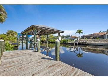 Spacious wooden dock with covered boat lift at 3494 Yukon Dr, Port Charlotte, FL 33948