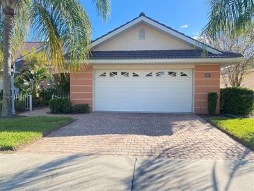 Single-story home with a white garage door and brick driveway at 2087 Lynx Run, North Port, FL 34288