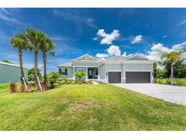 Single-Gathering home with two-car garage and palm trees at 9973 Calumet Blvd, Port Charlotte, FL 33981