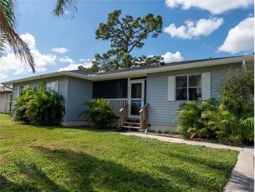 House exterior featuring a light blue color and landscaping at 860 Columbia St, Port Charlotte, FL 33948