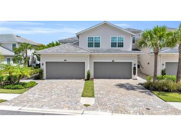 Two-story home with a two-car garage and paver driveway at 14625 Sycamore Ct # 2411, Punta Gorda, FL 33955