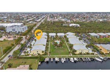 Stunning aerial view of the condo community with manicured lawns, boat docks, and a sparkling pool for relaxing and enjoying at 2000 Bal Harbor Blvd # 321, Punta Gorda, FL 33950