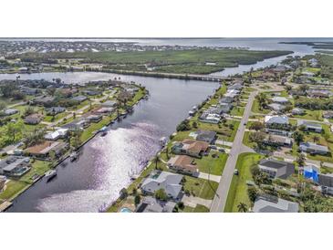 Beautiful aerial view of waterfront homes along a canal neighborhood with mature landscaping and waterfront access at 201 W Tarpon Nw Blvd, Port Charlotte, FL 33952
