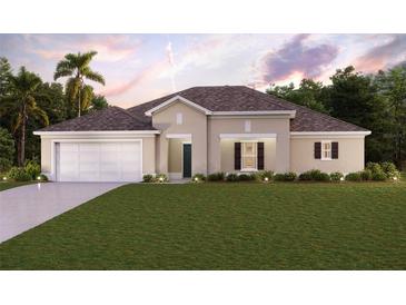 Single-story home with a two-car garage and landscaped lawn at 425 Rio De Janeiro Ave, Punta Gorda, FL 33983