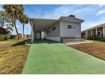 Charming home featuring a carport and well-maintained landscaping at 6450 Floral Ct, North Port, FL 34287