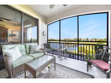 Relaxing screened patio area with comfortable seating and serene lake views for enjoying the outdoors at 1349 Aqui Esta Dr # 133, Punta Gorda, FL 33950