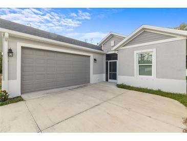 House exterior showcasing a gray garage door and driveway at 1497 Nordendale Blvd, North Port, FL 34288