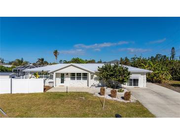 Single-story home with white exterior, landscaping, and driveway at 170 Chelsea Nw Ct, Port Charlotte, FL 33952