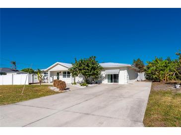 Charming single-story home with a welcoming front yard and paved driveway at 170 Chelsea Nw Ct, Port Charlotte, FL 33952