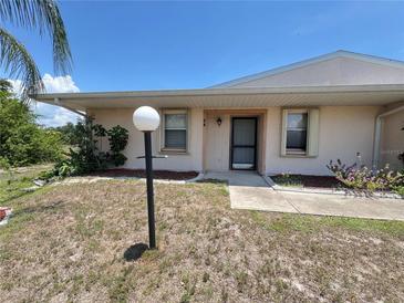 Charming front entrance with a well-lit walkway and a neatly maintained lawn at 25068 Harborview Rd # 1A, Punta Gorda, FL 33980