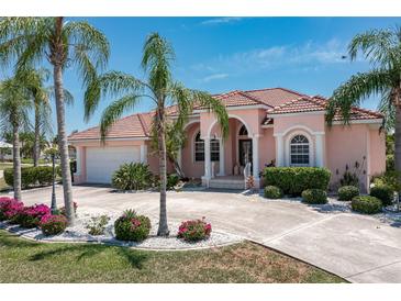 Charming two-story home with a terracotta roof and lush landscaping at 2507 Via Veneto Dr, Punta Gorda, FL 33950