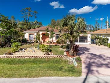 Inviting single-story home with landscaped front yard, driveway, and covered porch at 3646 Madagascar Ave, North Port, FL 34286