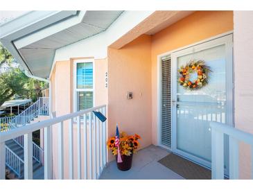 Condo front entry with wreath and balcony at 19310 Water Oak Dr # 203, Port Charlotte, FL 33948