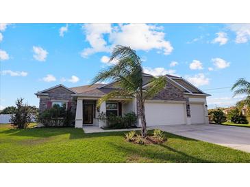 Single-Gathering home with stone facade and two-car garage at 2705 Lamkin Rd, North Port, FL 34288