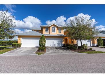 Tan two car garage with landscaping at 25623 Heritage Lake Blvd. # 57, Punta Gorda, FL 33983
