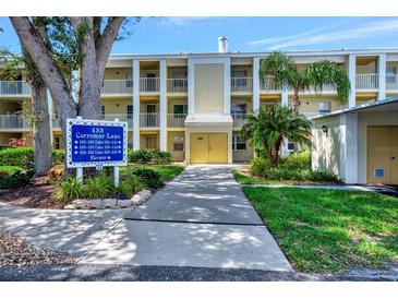 Building exterior with parking and landscaping at 433 Cerromar Ln # 441, Venice, FL 34293