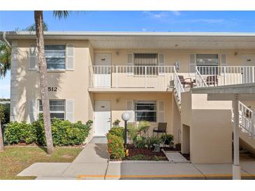 Two-story condo building with landscaped grounds and walkway at 1512 Rio De Janeiro Ave # 111, Punta Gorda, FL 33983